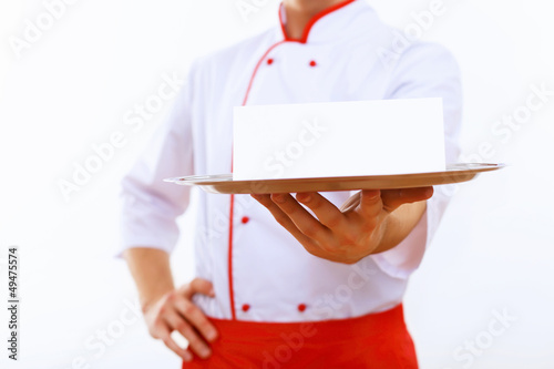Photo: Cook holding an empty tray Cook holding an empty tray