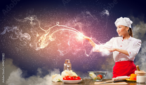Photo: Asian female cooking with magic Asian female cooking with magic