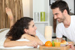 Couple eating breakfast in bed