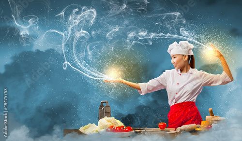Photo: Asian female cooking with magic Asian female cooking with magic