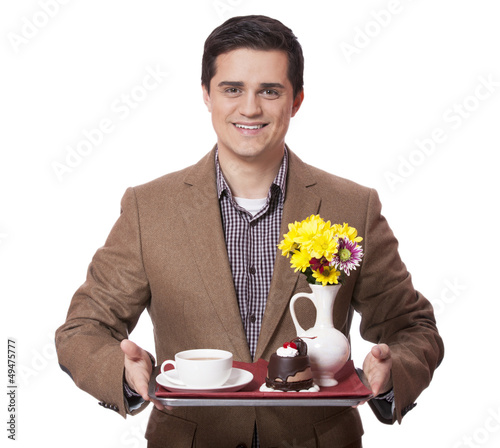 Photo: Man in suit holding tray with sweet breakfast Man in suit holding tray with sweet breakfast