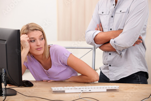 Photo: Young woman sprawling on her desk Young woman sprawling on her desk