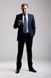Young and successful businessman holding a business card