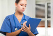 Nurse writing on a clipboard