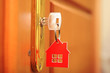 A key in a lock with house icon on it