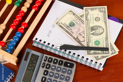 Photo: Bright wooden abacus and calculator. Conceptual photo of old Bright wooden abacus and calculator. Conceptual photo of old