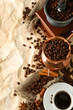 Cup of coffee, pot and grinder on beige background
