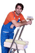 Man with rolls of wallpaper