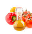 bottle with olive oil ,tomatoes and peppers on a white backgroun