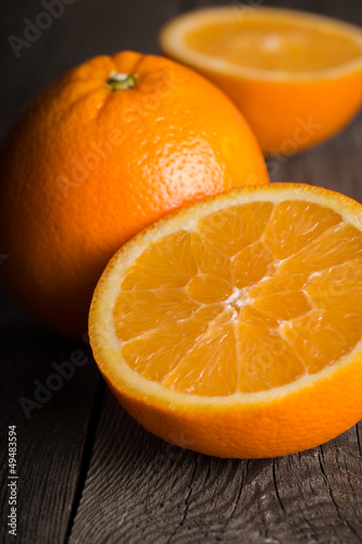 Photo: Close-up of orange fruit on wooden board. Close-up of orange fruit on wooden board.