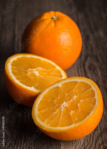 Photo: Close-up of orange fruit on the old wooden board. Close-up of orange fruit on the old wooden board.