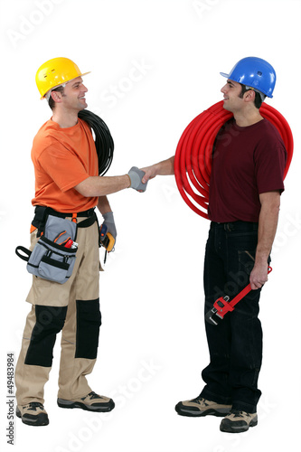Photo: Electrician and plumber shaking hands Electrician and plumber shaking hands