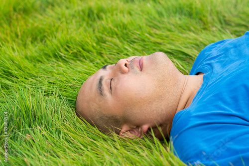Photo: Fat Man Lying on the Green Grass to Relax. Fat Man Lying on the Green Grass to Relax.