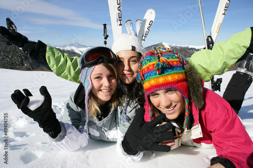 Photo: Three female friends laying in the snow Three female friends laying in the snow