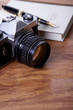 Camera and book with fountain pen, close up