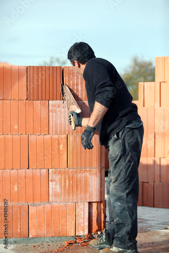 Photo: Builder laying blocks Builder laying blocks