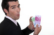 Rich businessman showing off his money