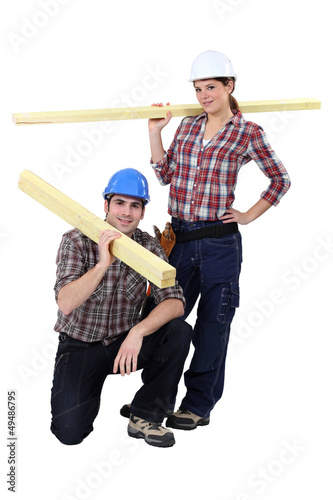 Photo: Labourers carrying wooden planks Labourers carrying wooden planks