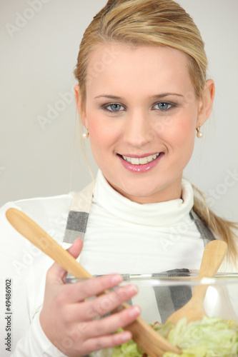 Photo: Blond holding salad bowl Blond holding salad bowl
