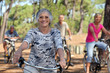 Foto: old woman and three other people doing bike in the forest old woman and three other people doing bike in the forest