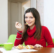  woman eats chicken with rice and vegetables