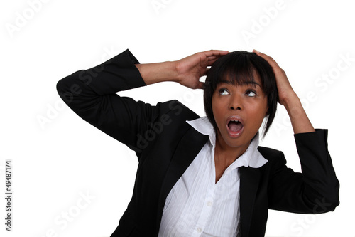 Photo: Scared businesswoman shielding her head Scared businesswoman shielding her head