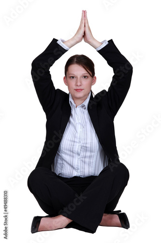 Photo: Businesswoman practicing yoga Businesswoman practicing yoga