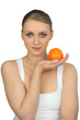 Young woman holding an orange