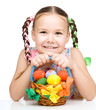 Little girl with basket full of colorful eggs