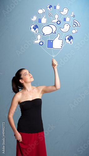 Photo: Pretty woman holding social icon balloon Pretty woman holding social icon balloon