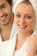 Couple in bath robes getting ready