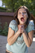 excited young woman outside in a park