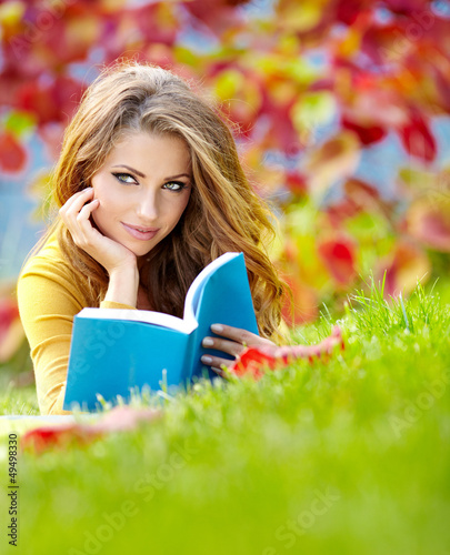 Photo: beautiful girl with book in the spring park beautiful girl with book in the spring park