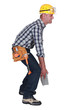 Mason struggling to carry brick