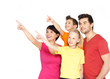 family with two children pointing finger up