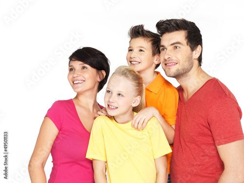 Photo: Happy family with two children looking side Happy family with two children looking side