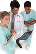 medical professionals discussing results of a patient's x-ray