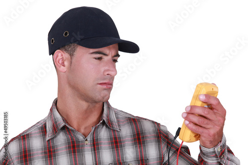 Photo: Man with a voltmeter Man with a voltmeter