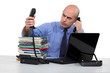 Businessman struggling with two phone calls