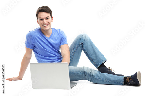 Photo: Young man sitting with laptop Young man sitting with laptop