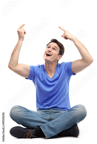 Photo: Young man pointing above his head Young man pointing above his head