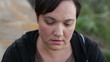 Sad woman looking down close