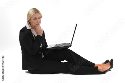 Photo: Businesswoman sitting on the floor with her laptop Businesswoman sitting on the floor with her laptop