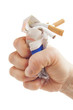 Human fist breaking cigarettes on white background