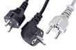 Two black and one white electric plugs isolated on white