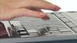 Woman types text on keyboard.