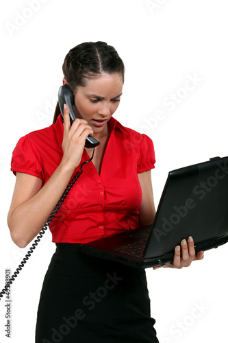 Illustration: Young woman with laptop and phone Young woman with laptop and phone