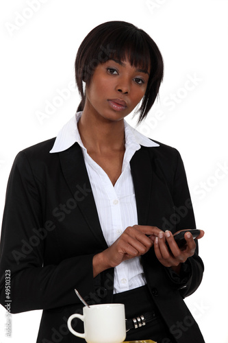 Illustration: Businesswoman tapping a cellphone Businesswoman tapping a cellphone