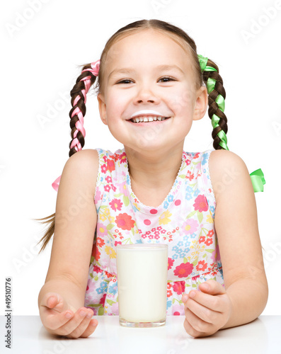 Photo: Cute little girl showing milk moustache Cute little girl showing milk moustache