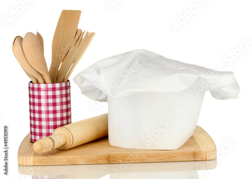 Photo: Chef's hat with spoons and battledore isolated on white Chef's hat with spoons and battledore isolated on white